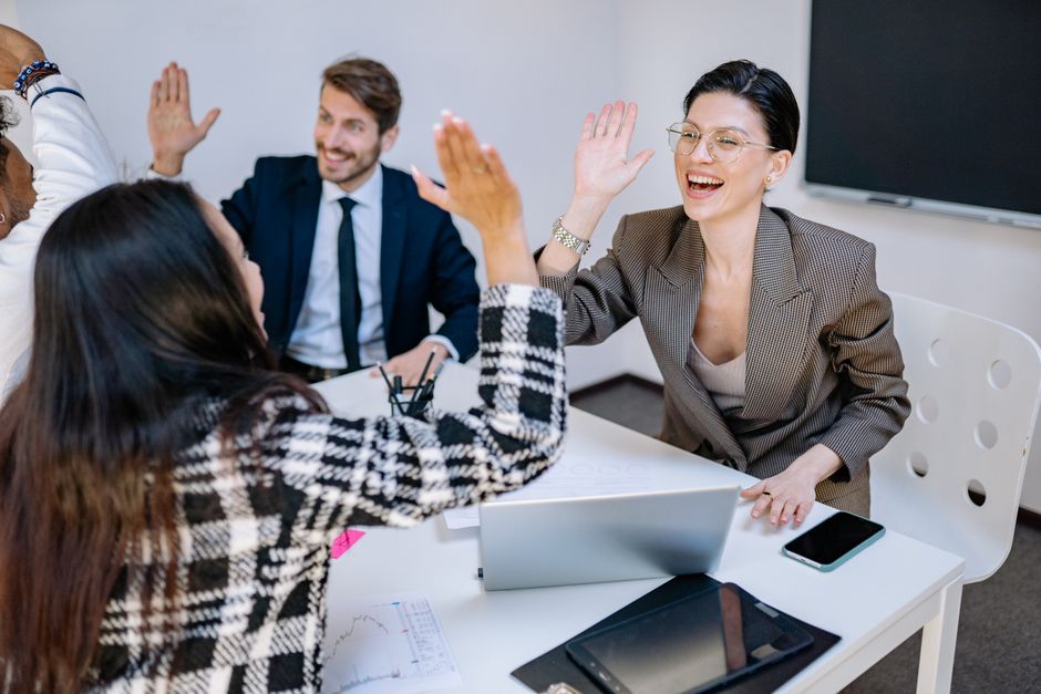 A recruitment desk team celebrating a placement